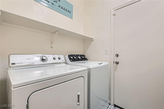 clothes washing area featuring laundry area and washer and clothes dryer