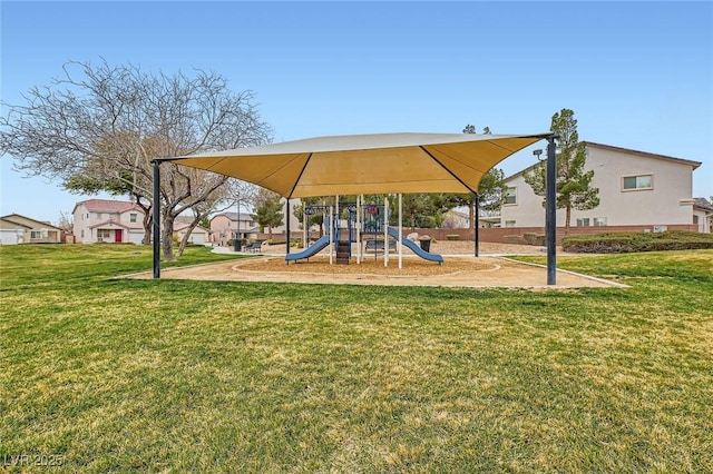 community jungle gym featuring a residential view and a lawn