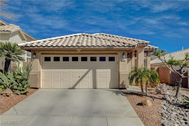 view of front of property featuring a tiled roof, an attached garage, driveway, and stucco siding