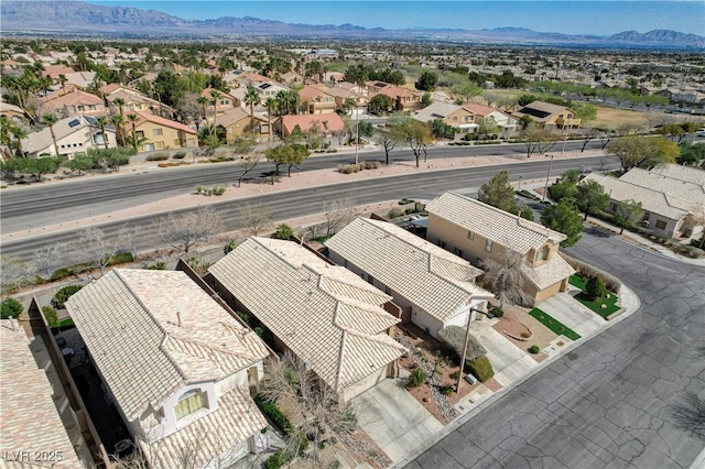 drone / aerial view featuring a residential view and a mountain view