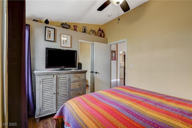 bedroom featuring a ceiling fan, vaulted ceiling, and dark wood-type flooring