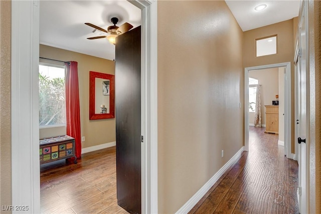 hall featuring baseboards and wood finished floors