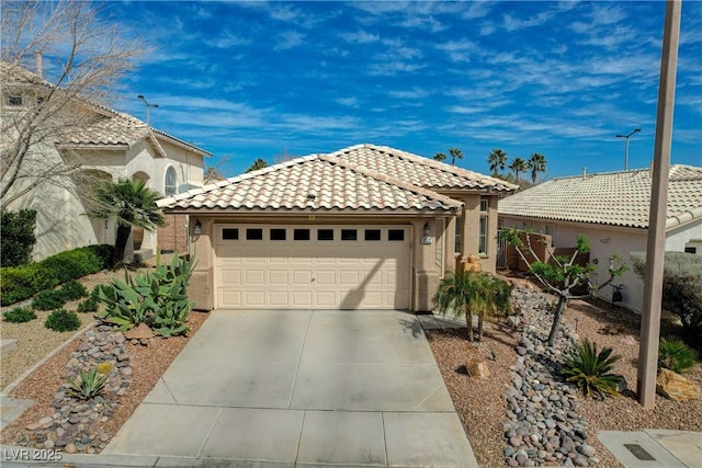 view of front of house featuring a garage, a tiled roof, concrete driveway, and stucco siding