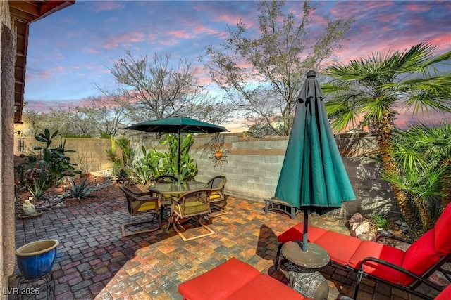 view of patio featuring outdoor dining area and a fenced backyard