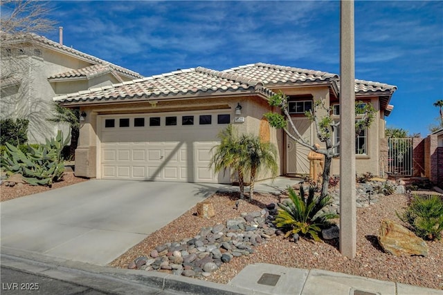 view of front facade with concrete driveway, a tiled roof, an attached garage, and stucco siding