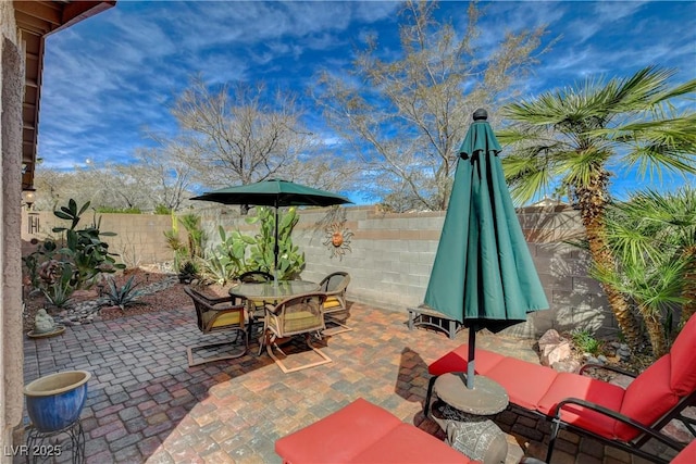 view of patio / terrace featuring outdoor dining space and a fenced backyard