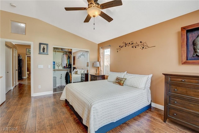 bedroom featuring vaulted ceiling, hardwood / wood-style floors, a closet, and baseboards