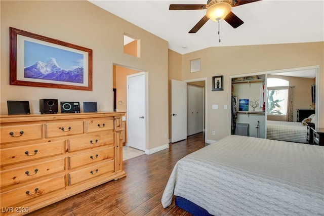 bedroom featuring a ceiling fan, vaulted ceiling, baseboards, and wood finished floors