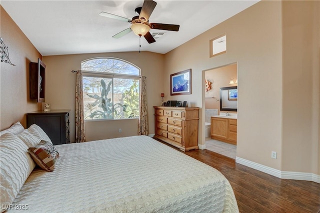 bedroom with ensuite bathroom, ceiling fan, wood finished floors, visible vents, and baseboards