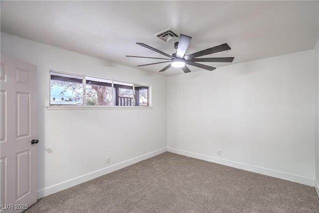 carpeted spare room with visible vents, ceiling fan, and baseboards