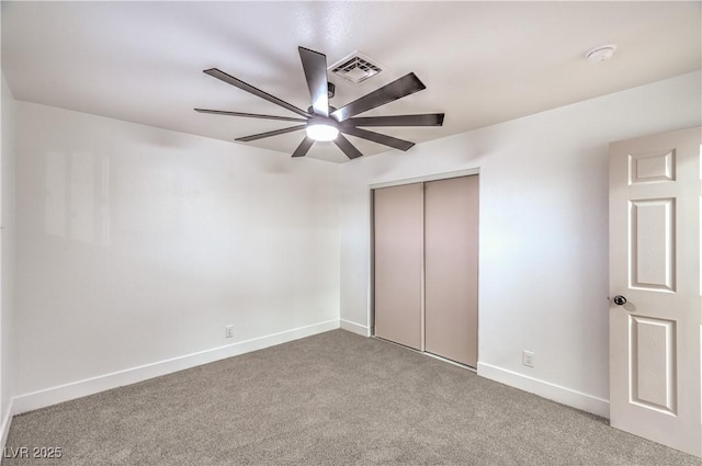 unfurnished bedroom with a ceiling fan, visible vents, baseboards, a closet, and carpet