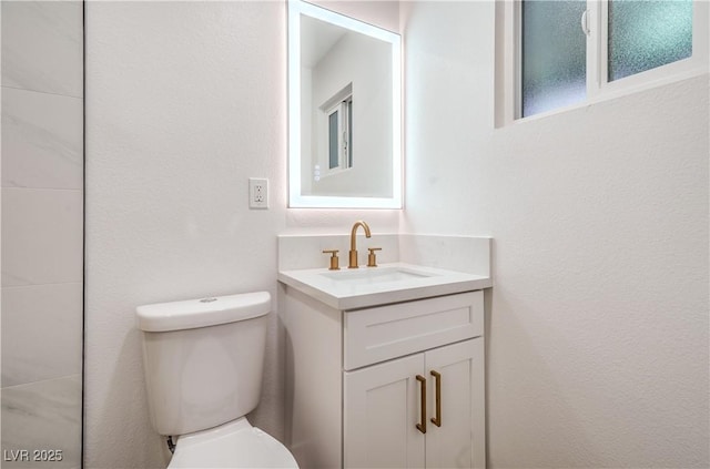 bathroom featuring toilet and vanity