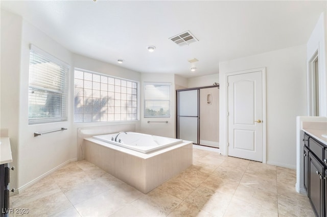 bathroom featuring a garden tub, vanity, visible vents, baseboards, and a stall shower