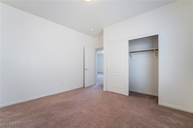 unfurnished bedroom with a closet, carpet flooring, and baseboards