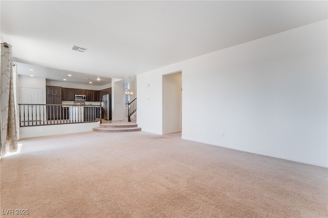 unfurnished room with stairs, recessed lighting, visible vents, and light colored carpet