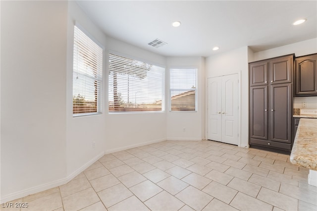 unfurnished room featuring recessed lighting, visible vents, baseboards, and light tile patterned flooring