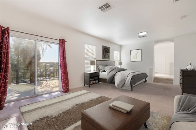 bedroom featuring carpet floors, access to outside, visible vents, and arched walkways