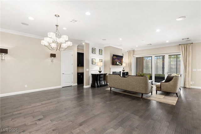 living area with a fireplace, crown molding, recessed lighting, wood finished floors, and baseboards