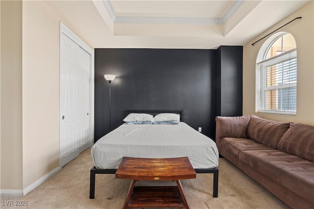 bedroom with light carpet, baseboards, ornamental molding, and a raised ceiling