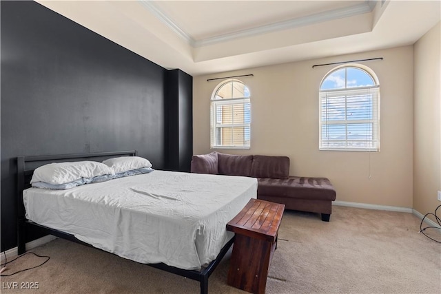 carpeted bedroom with ornamental molding, a tray ceiling, multiple windows, and baseboards