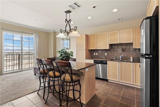 kitchen with visible vents, light brown cabinets, appliances with stainless steel finishes, and a sink