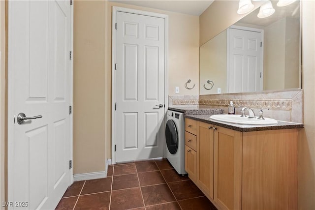 bathroom with vanity, backsplash, tile patterned flooring, and washer / dryer