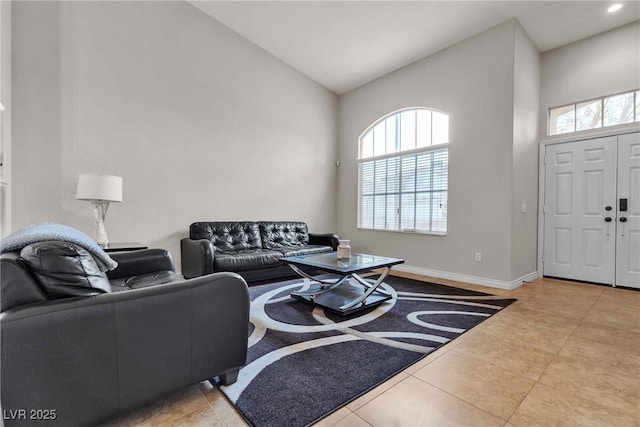 tiled living area with plenty of natural light, baseboards, vaulted ceiling, and recessed lighting