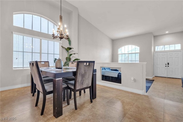 dining space with light tile patterned floors, recessed lighting, an inviting chandelier, high vaulted ceiling, and baseboards