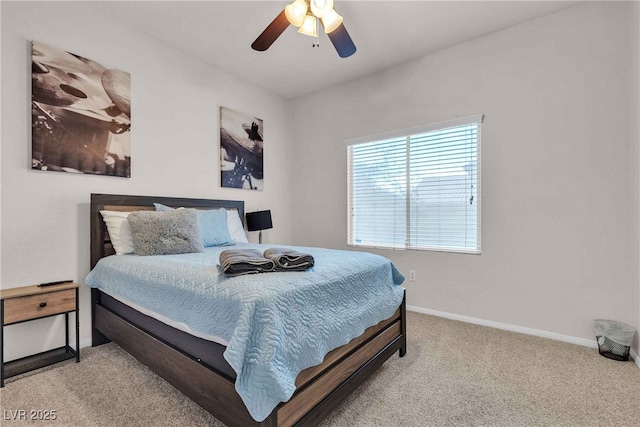 bedroom with ceiling fan, carpet flooring, and baseboards