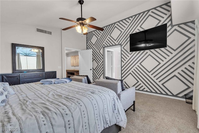 carpeted bedroom featuring lofted ceiling, visible vents, an accent wall, a ceiling fan, and wallpapered walls