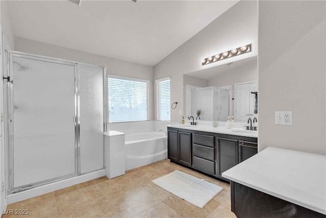 full bath with double vanity, lofted ceiling, a sink, a shower stall, and a bath