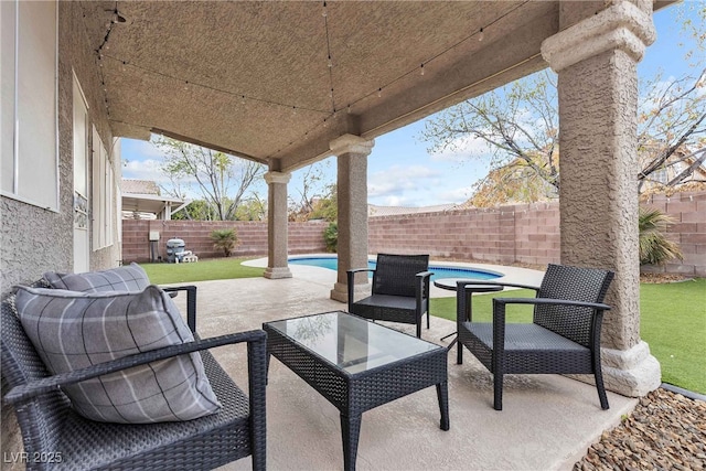 view of patio / terrace with a fenced in pool, a fenced backyard, and outdoor lounge area