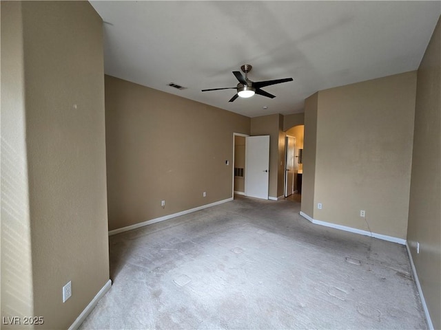 spare room featuring visible vents, arched walkways, ceiling fan, and baseboards