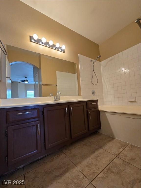 bathroom with tile patterned floors, ceiling fan, tub / shower combination, and vanity