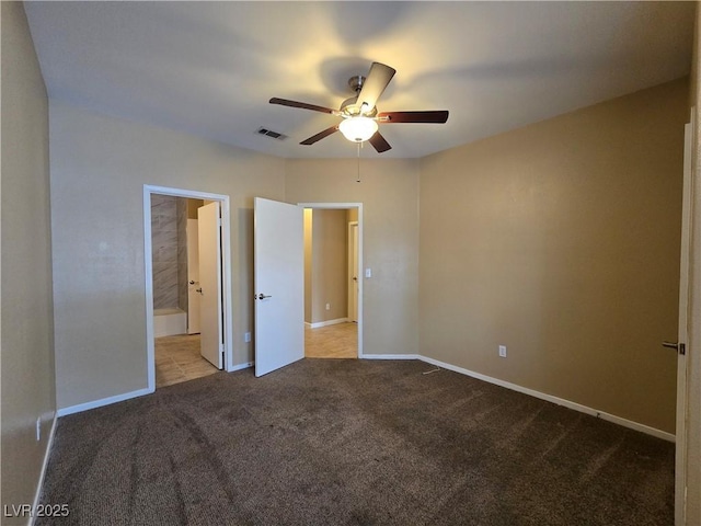 unfurnished bedroom featuring carpet floors, connected bathroom, visible vents, and baseboards