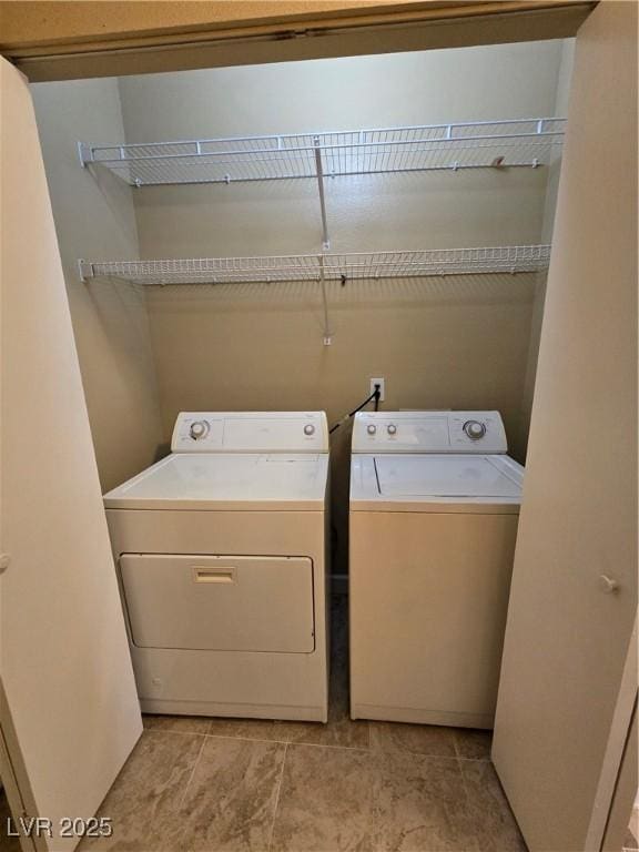 laundry area with laundry area and washer and clothes dryer