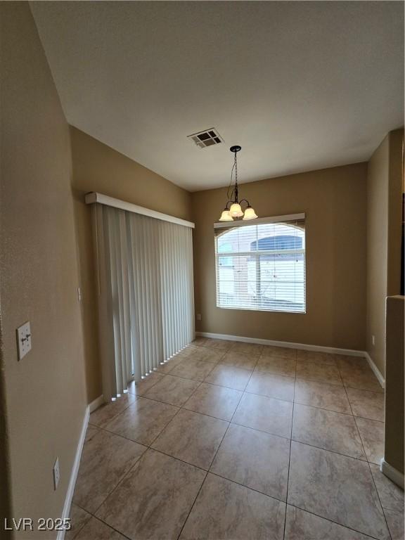 spare room with light tile patterned floors, visible vents, and baseboards