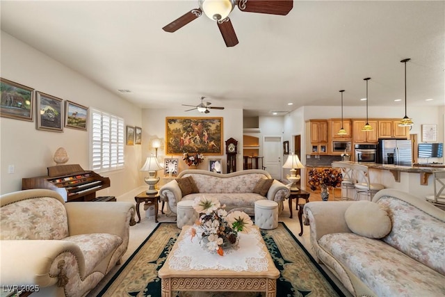 living room with visible vents and ceiling fan