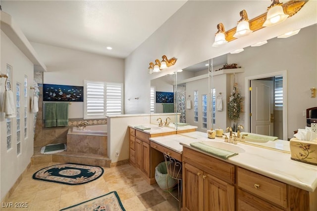 bathroom featuring tile patterned flooring, two vanities, a sink, and a bath