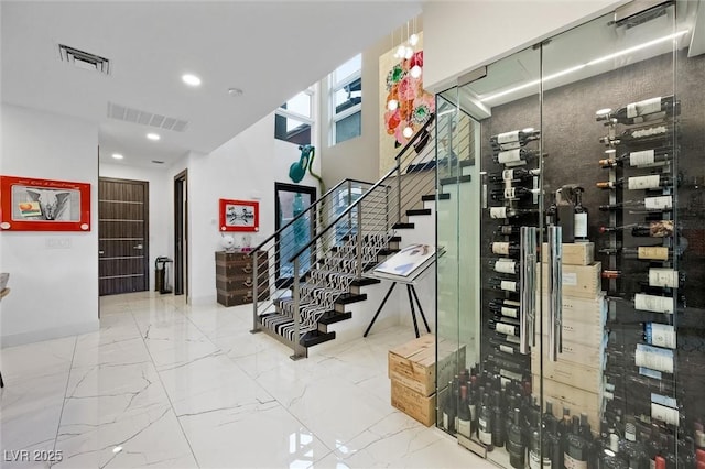 wine cellar with marble finish floor, visible vents, and recessed lighting