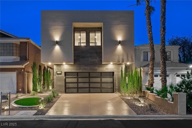 contemporary home featuring driveway and an attached garage