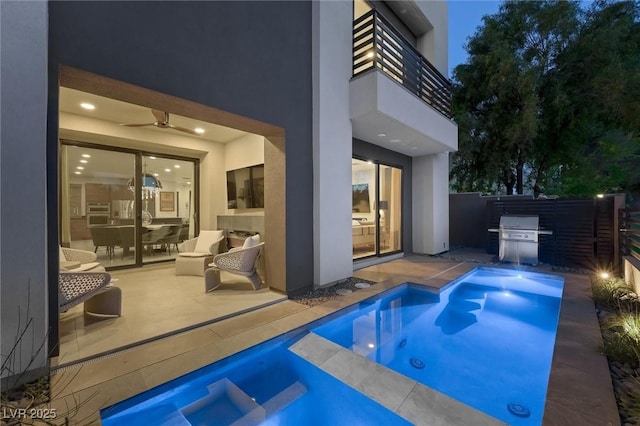 view of swimming pool featuring a patio, ceiling fan, a grill, fence, and an in ground hot tub