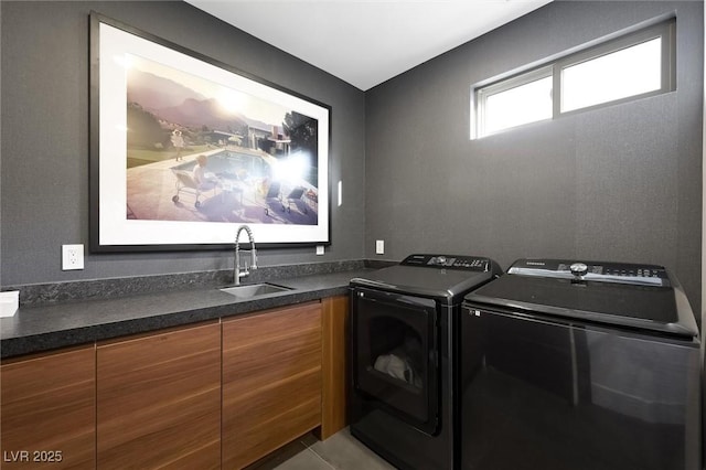 laundry area featuring laundry area, a sink, and washing machine and clothes dryer