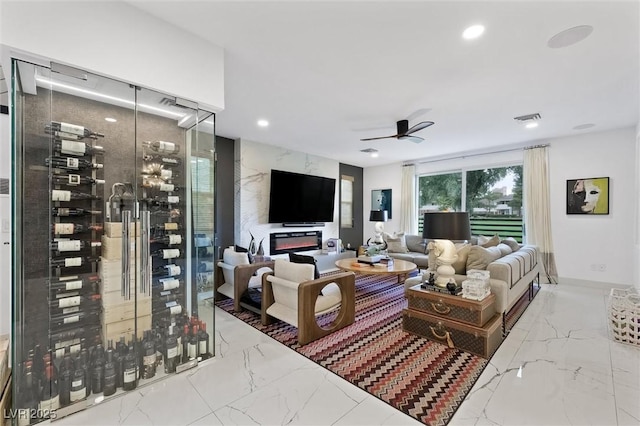 living room featuring ceiling fan, recessed lighting, visible vents, marble finish floor, and electric panel