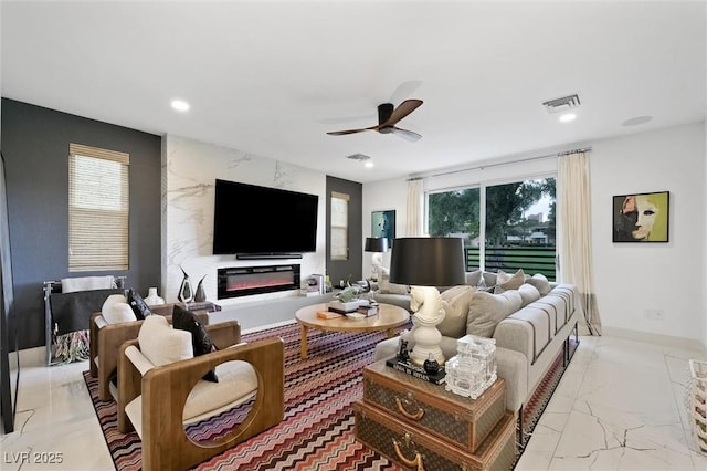 living room with ceiling fan, recessed lighting, visible vents, marble finish floor, and a glass covered fireplace