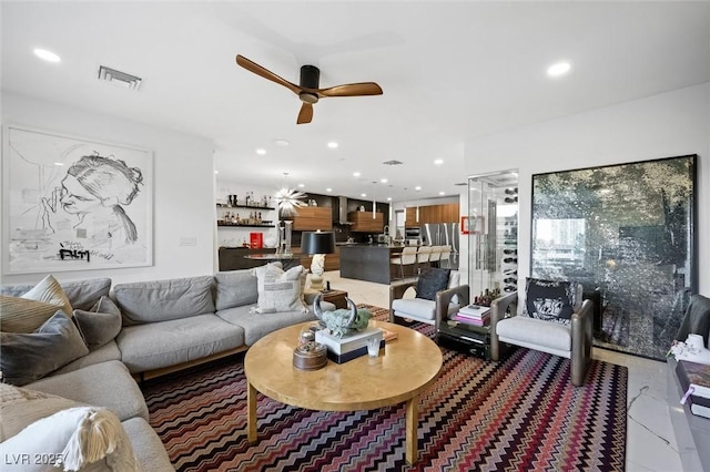 living area with recessed lighting, visible vents, and ceiling fan