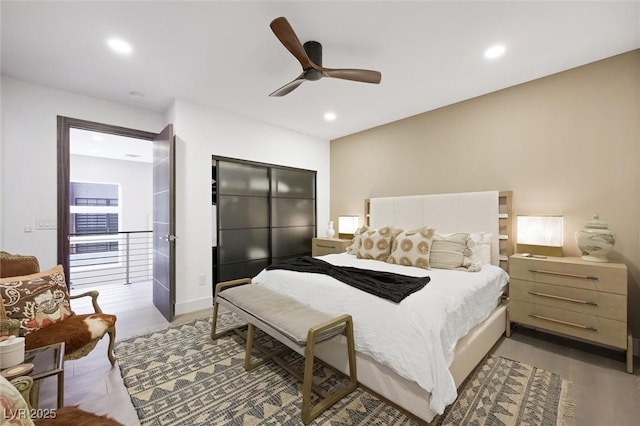 bedroom featuring light wood-type flooring, recessed lighting, and ceiling fan