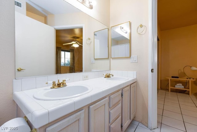 full bath featuring double vanity, visible vents, a sink, and tile patterned floors