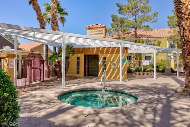 view of swimming pool with fence, a gate, and a pergola