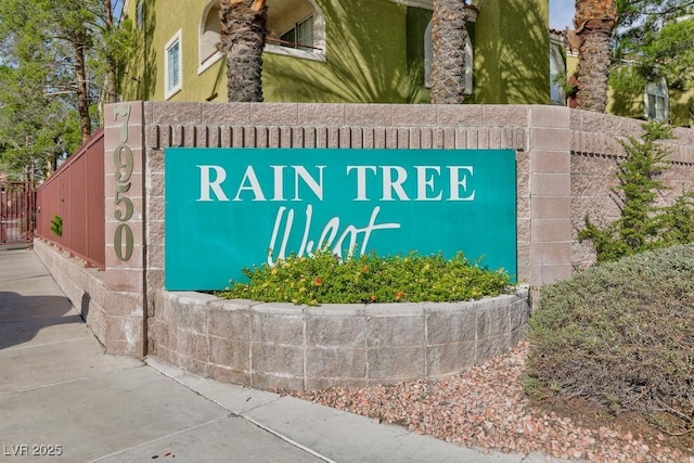 community / neighborhood sign with fence